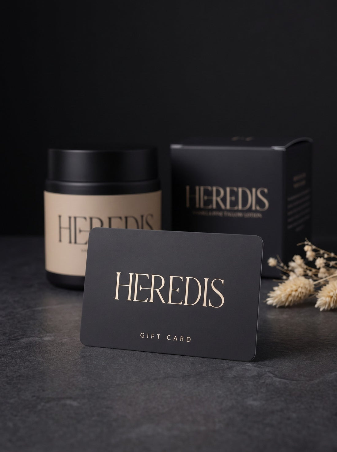 Heredis gift card in black and cream beside a jar of Vanilla Pine Tallow Lotion